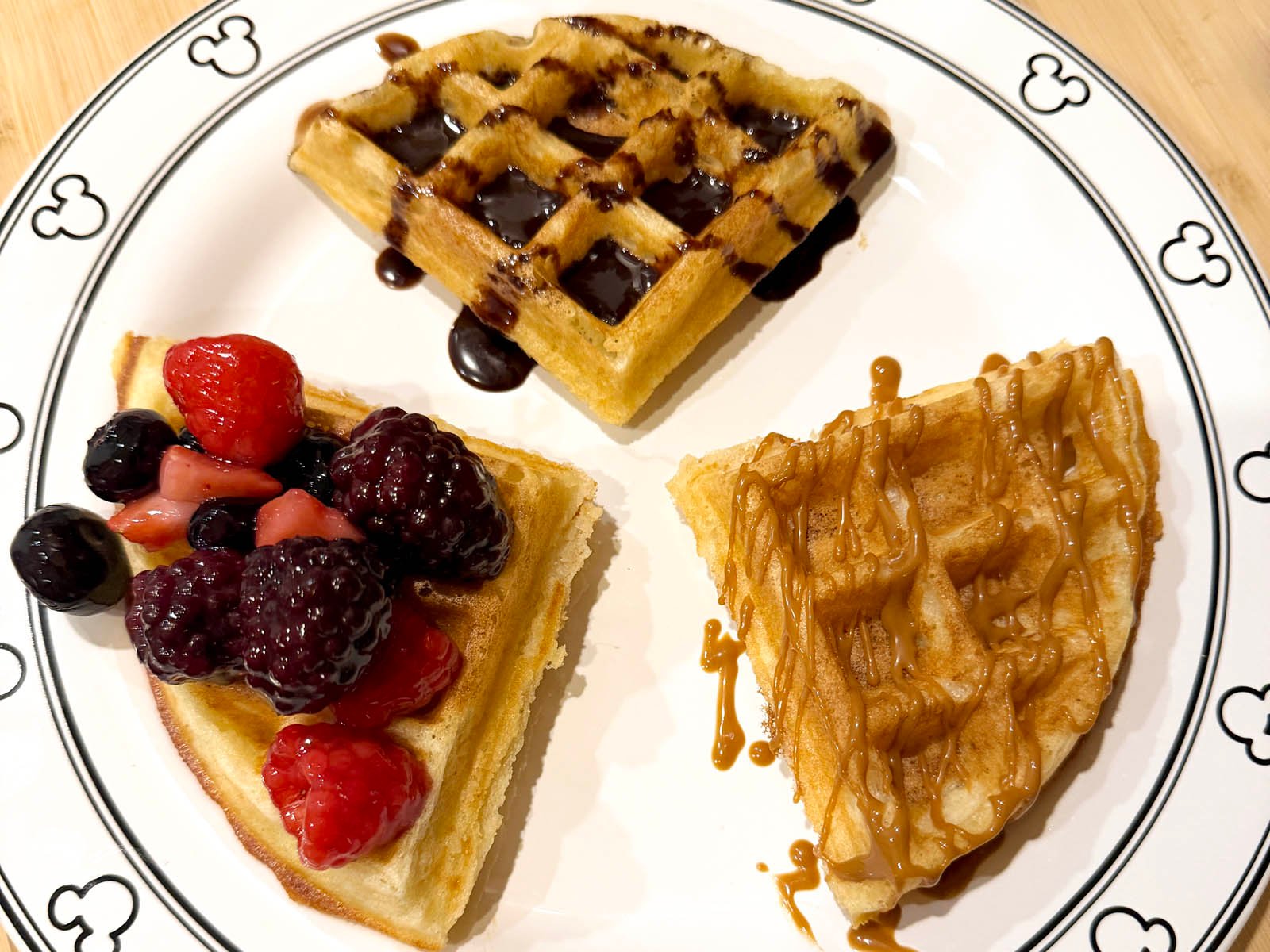 variations of the epcot belgian waffle recipe with berry compote, caramel drizzle, and chocolate sauce